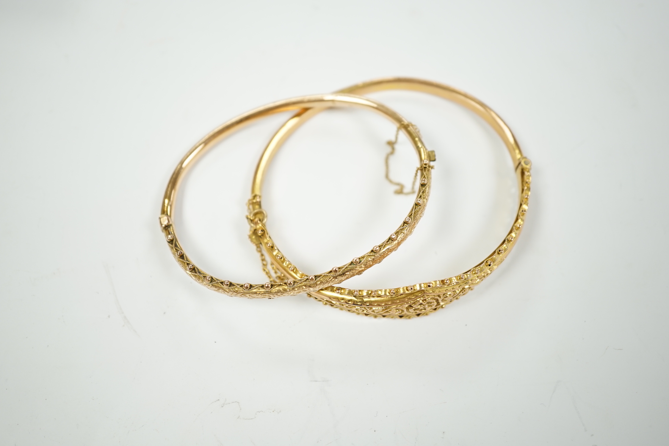 Two yellow metal hinged bracelets, one stamped 9ct gold, hallmarked bracelet 9.2 grams.